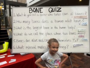 Young student in front of bone quiz she aced