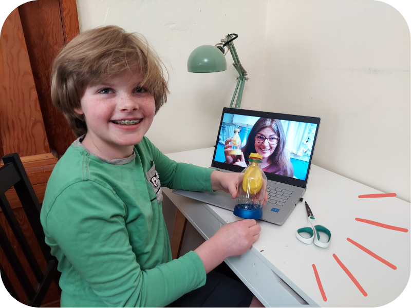 Student sitting at a laptop where Dr. Robin is demonstrating and student is doing physician led science curriculum for kids